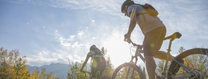 Two cyclists on a trail in the mountains.