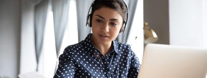 Young woman studying on a laptop.