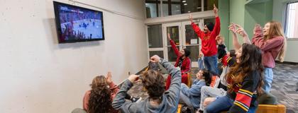 Students watching TV in the south residence lounge area