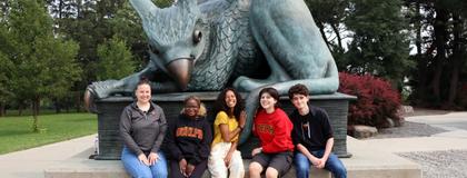 students with gryphon statue