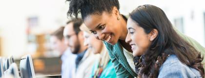 Two women learning at a computer.