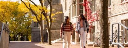 Two students walking outside Residence