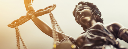 A statue of a woman representing justice holding a set of scales.