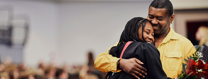 A University of Guelph student hugging her dad at her graduation ceremony