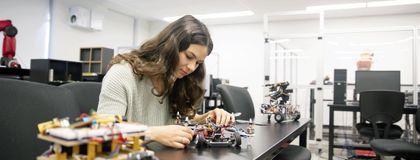 female student working on a small robot