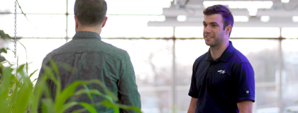declan barber on the right, talking to someone in a greenhouse